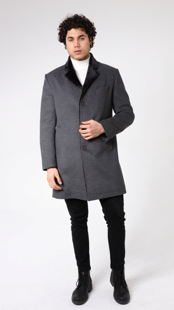 Man wearing a gray coat on a white background