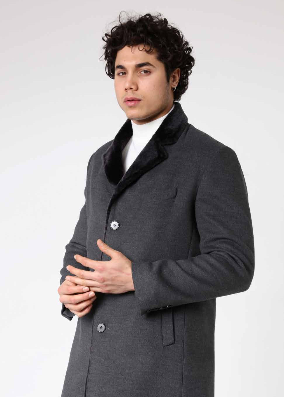 Man wearing a gray coat with a white background