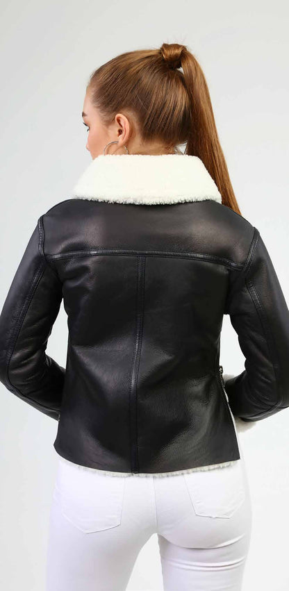 Black leather jacket with white fur collar worn by a person on a white background