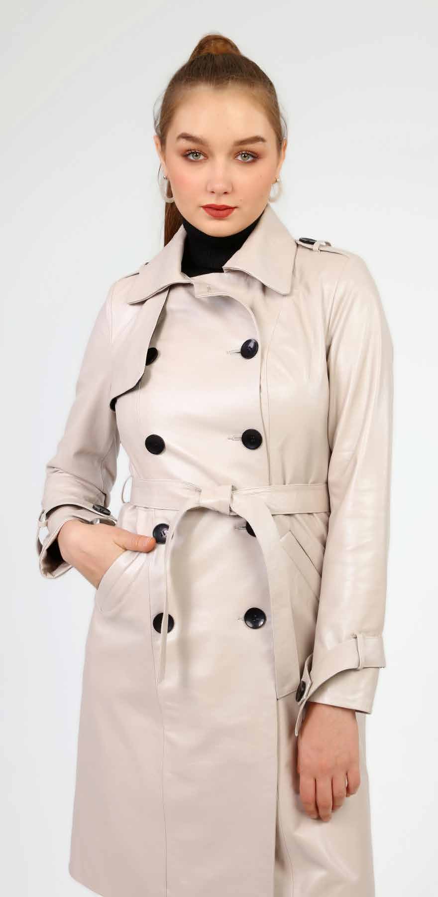 Woman wearing a beige trench coat on a white background