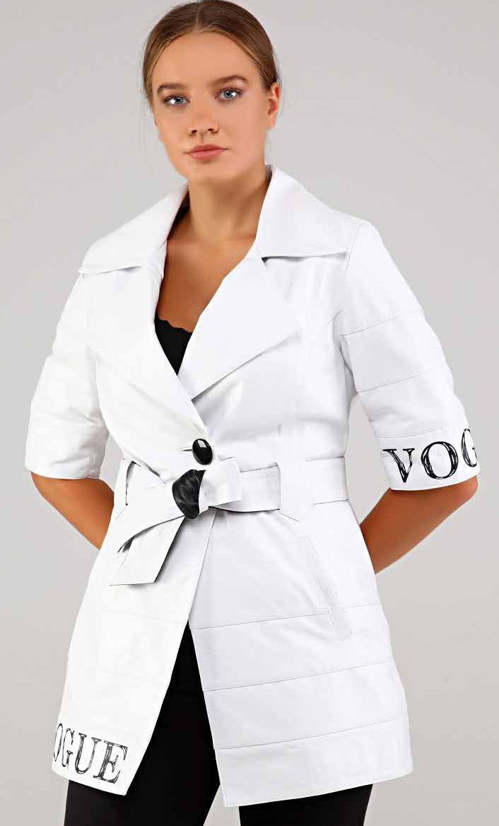 Woman wearing a white coat with 'Vogue' branding on a gray background