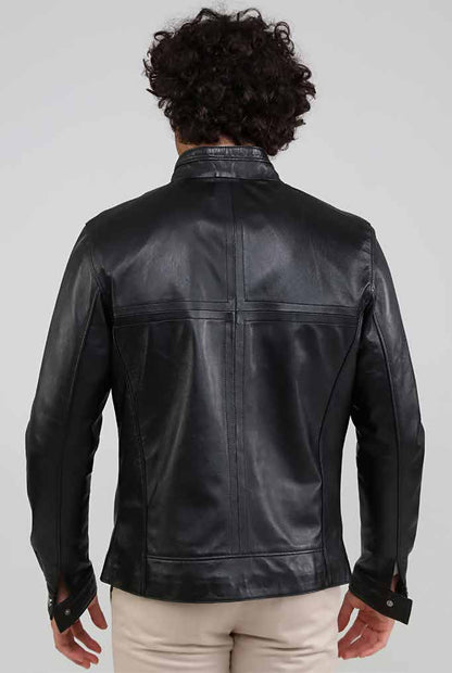 Man wearing a black leather jacket on a plain background