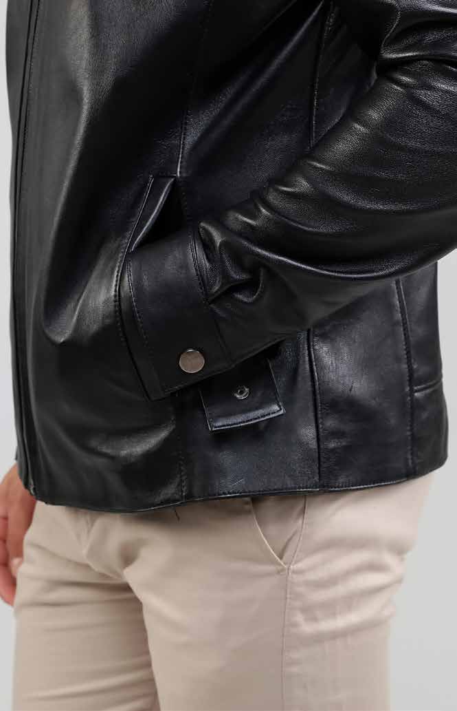 Black leather jacket worn by a person on a plain background