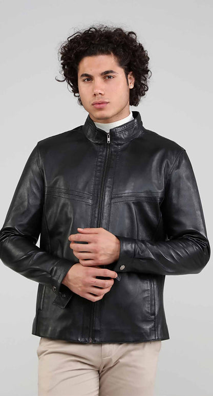 Man wearing a black leather jacket on a gray background