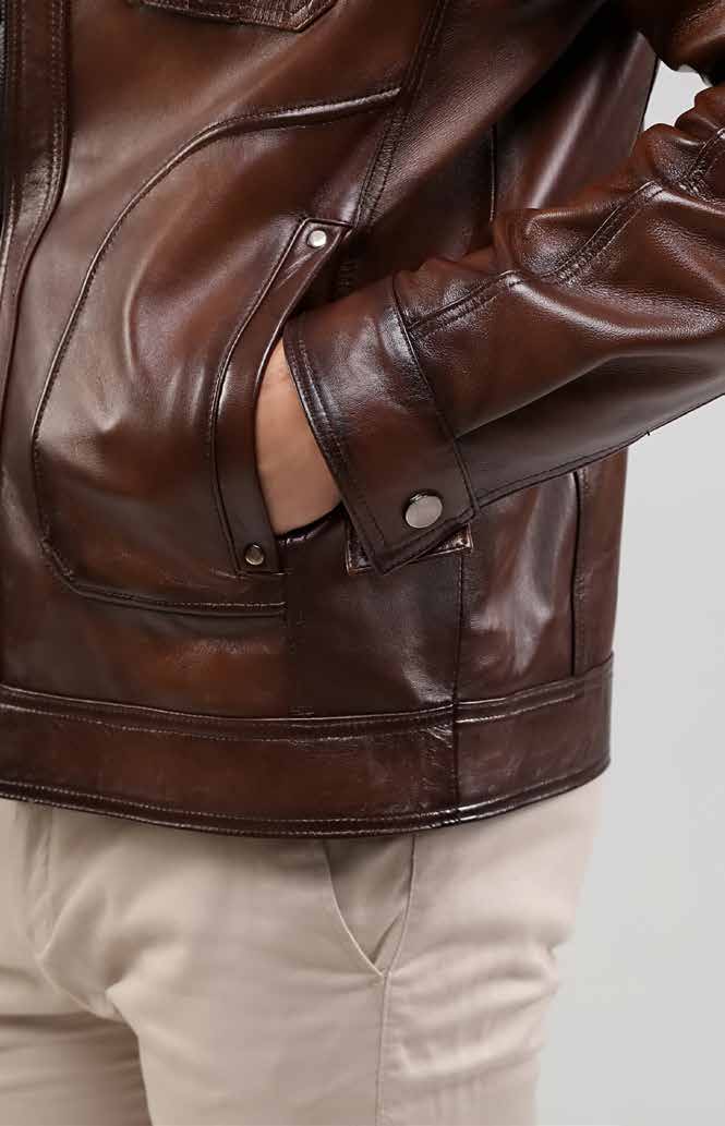 Close-up of a brown leather jacket on a neutral background