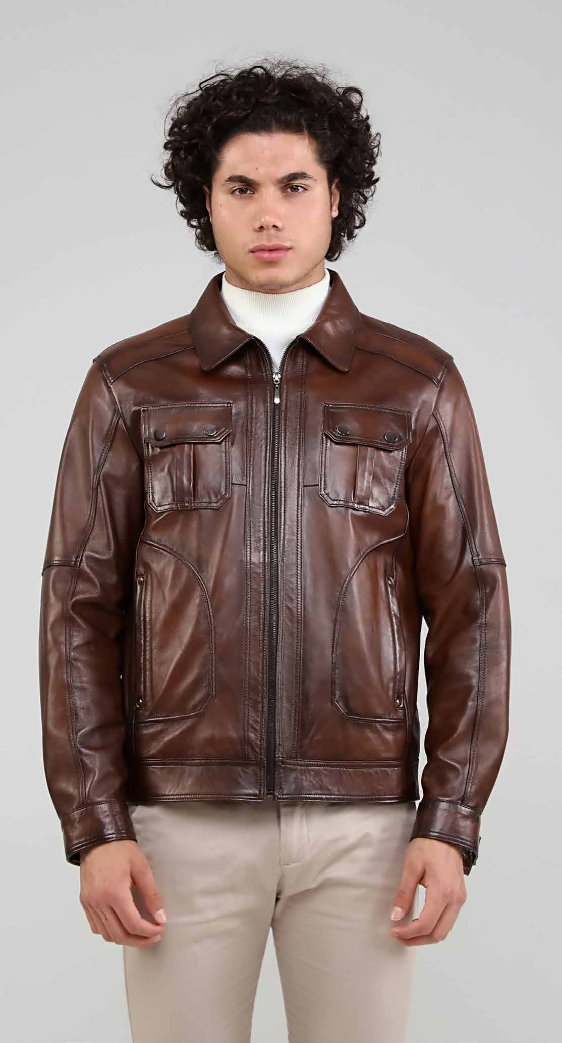 Man wearing a brown leather jacket on a plain background