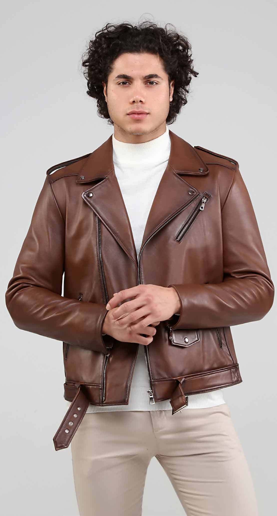 Man wearing a brown leather jacket on a plain background
