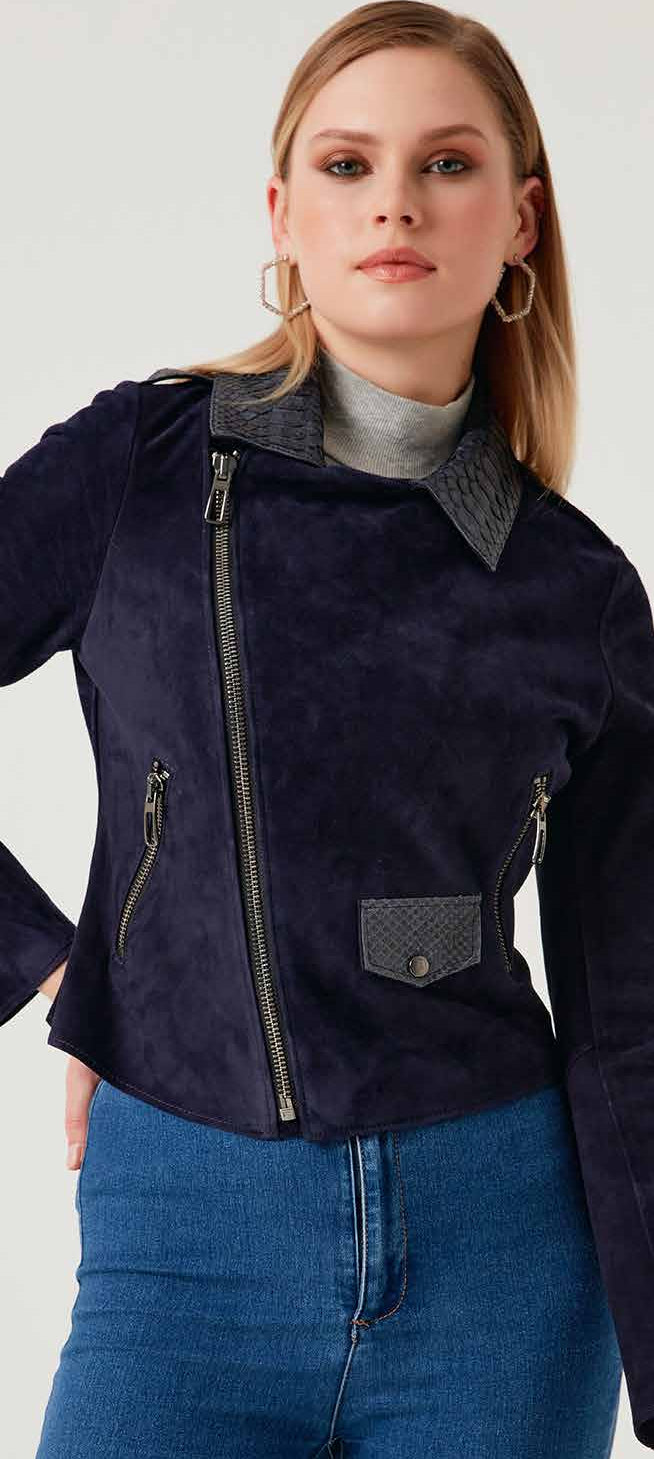 Woman wearing a dark blue lamb jacket with a gray collar on a white background