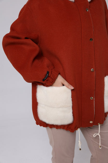 Red jacket with white fur lining on a plain background