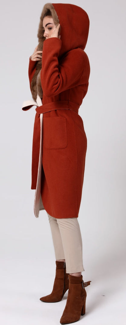 Woman wearing a red hooded coat on a white background