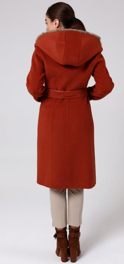 Woman wearing a red coat with fur hood on a white background