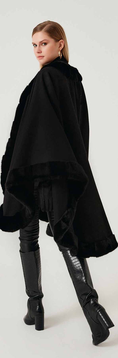 Woman wearing a black mink fur and boots on a white background