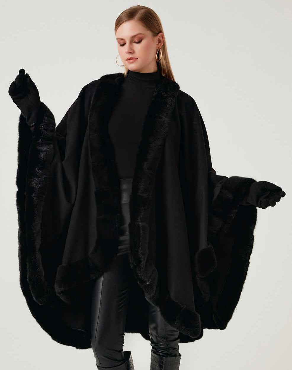 Woman wearing a black mink fur shawl on a white background