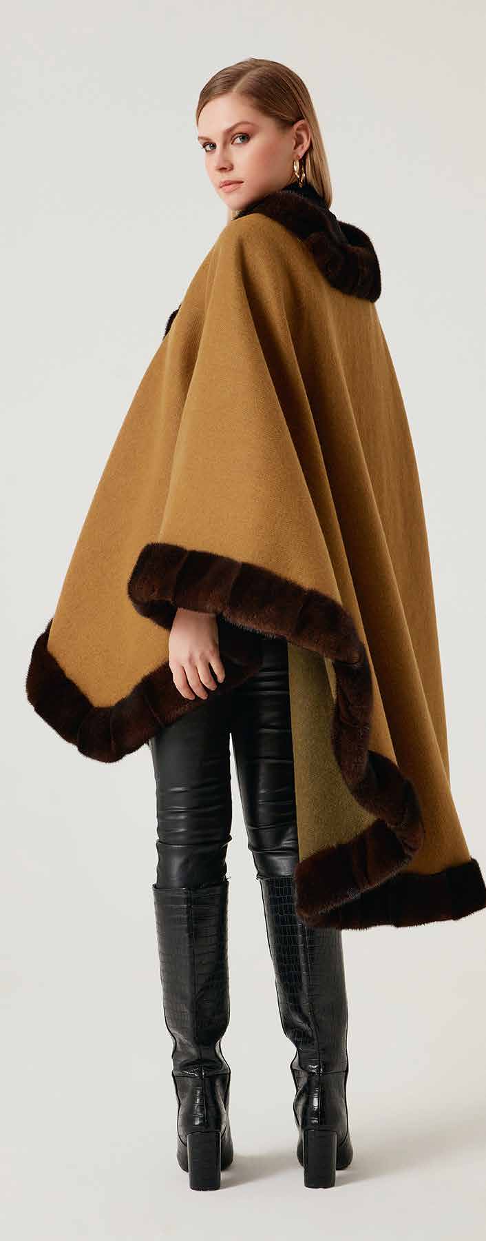 Woman wearing a brown shawl with mink fur on a white background