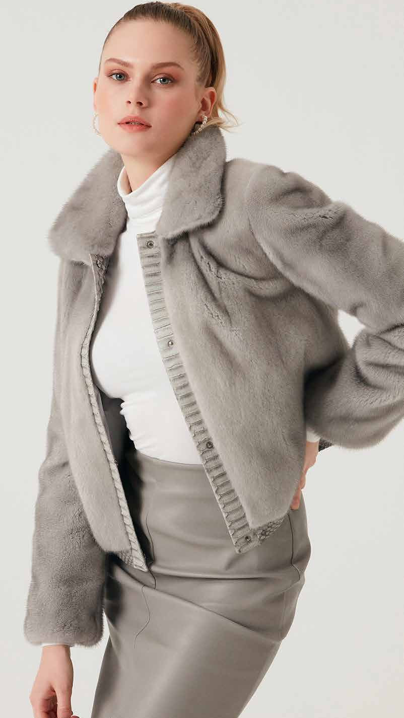 Woman wearing a gray coat and pants on a white background