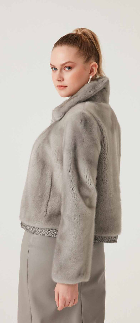 Woman wearing a gray fleece jacket on a white background