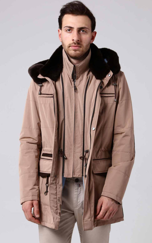 Man wearing a beige coat with fur collar on a white background