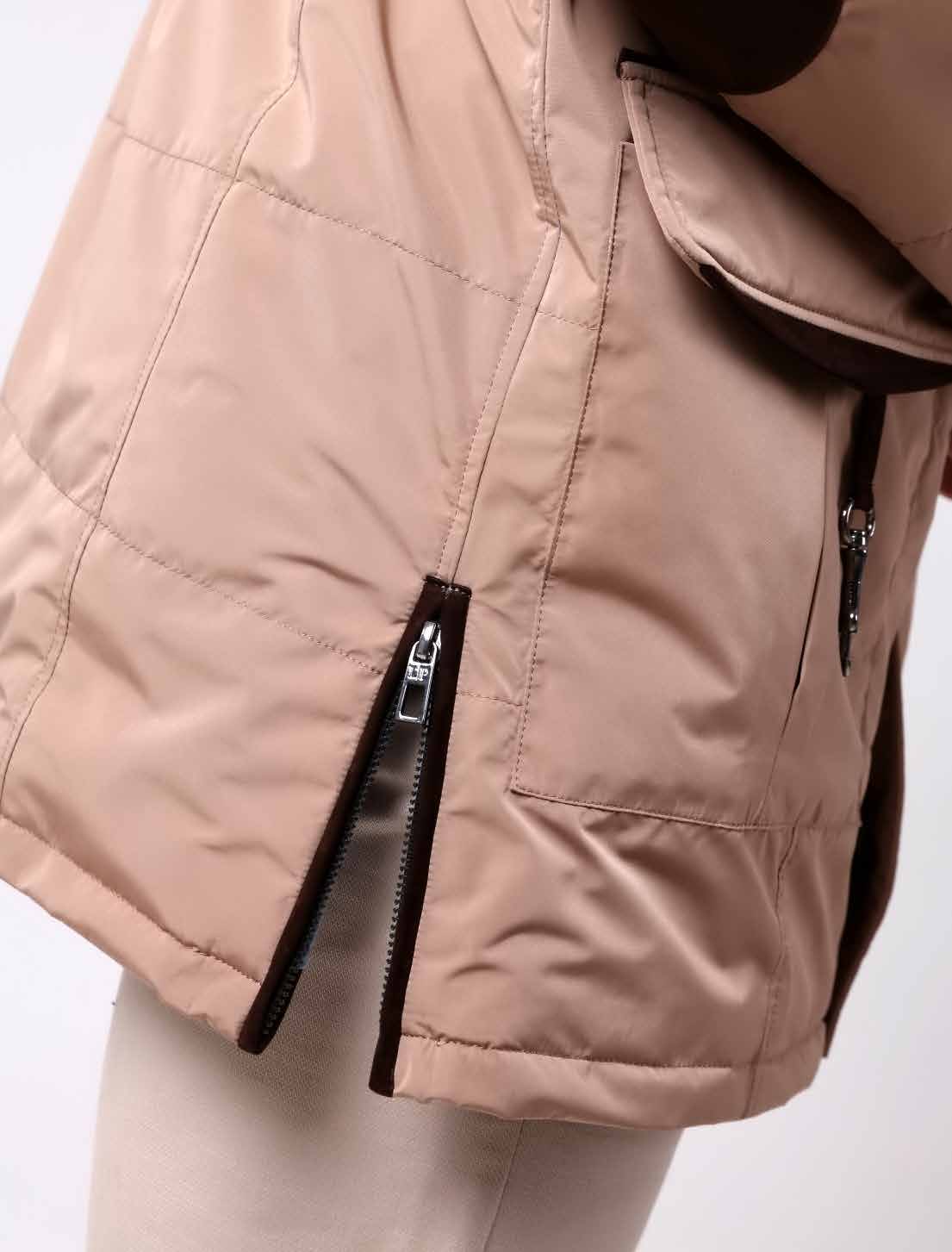Close-up of a beige puffer vest with a zipper on a light gray background