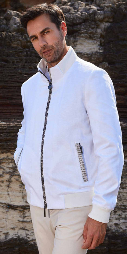 Man wearing a white jacket with a textured background
