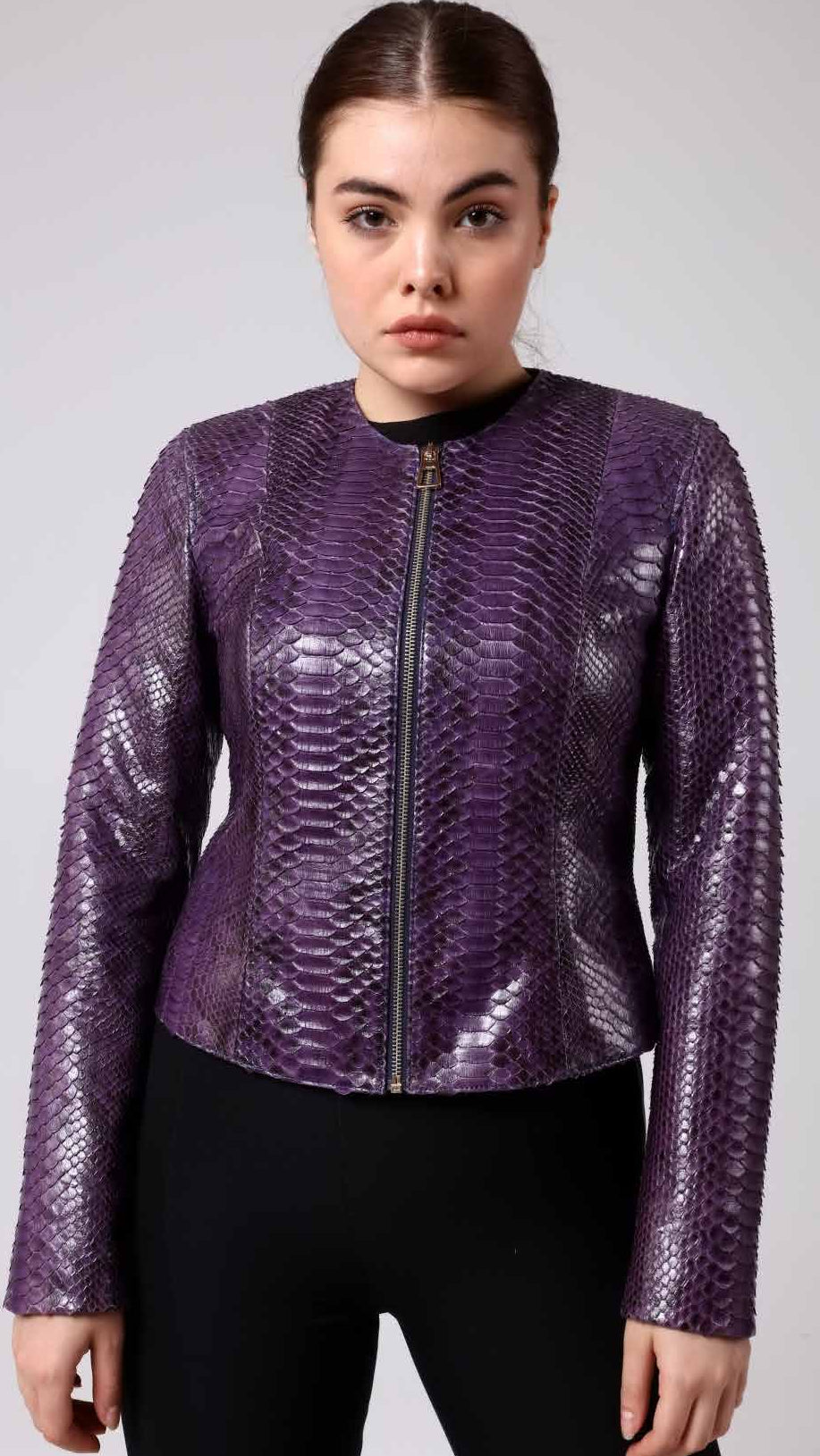 Woman wearing a purple phyton jacket on a plain background