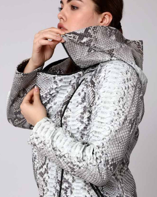 Person wearing a silver and gray phyton jacket on a plain background