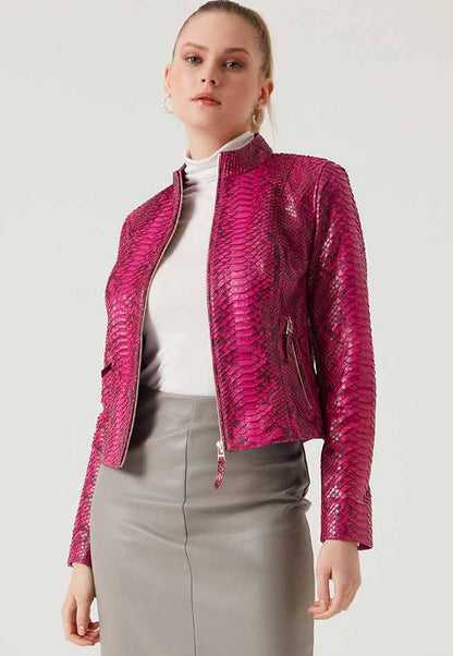 Woman wearing a pink phyton jacket over a white shirt and gray skirt on a white background