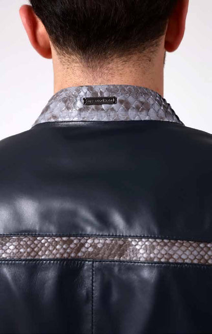 Close-up of a person wearing a black leather jacket with a patterned collar and visible brand label.