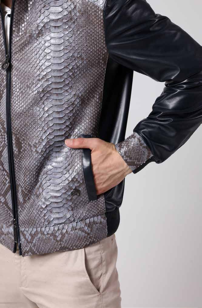 Man wearing a black leather jacket with a snake skin pattern on a white background