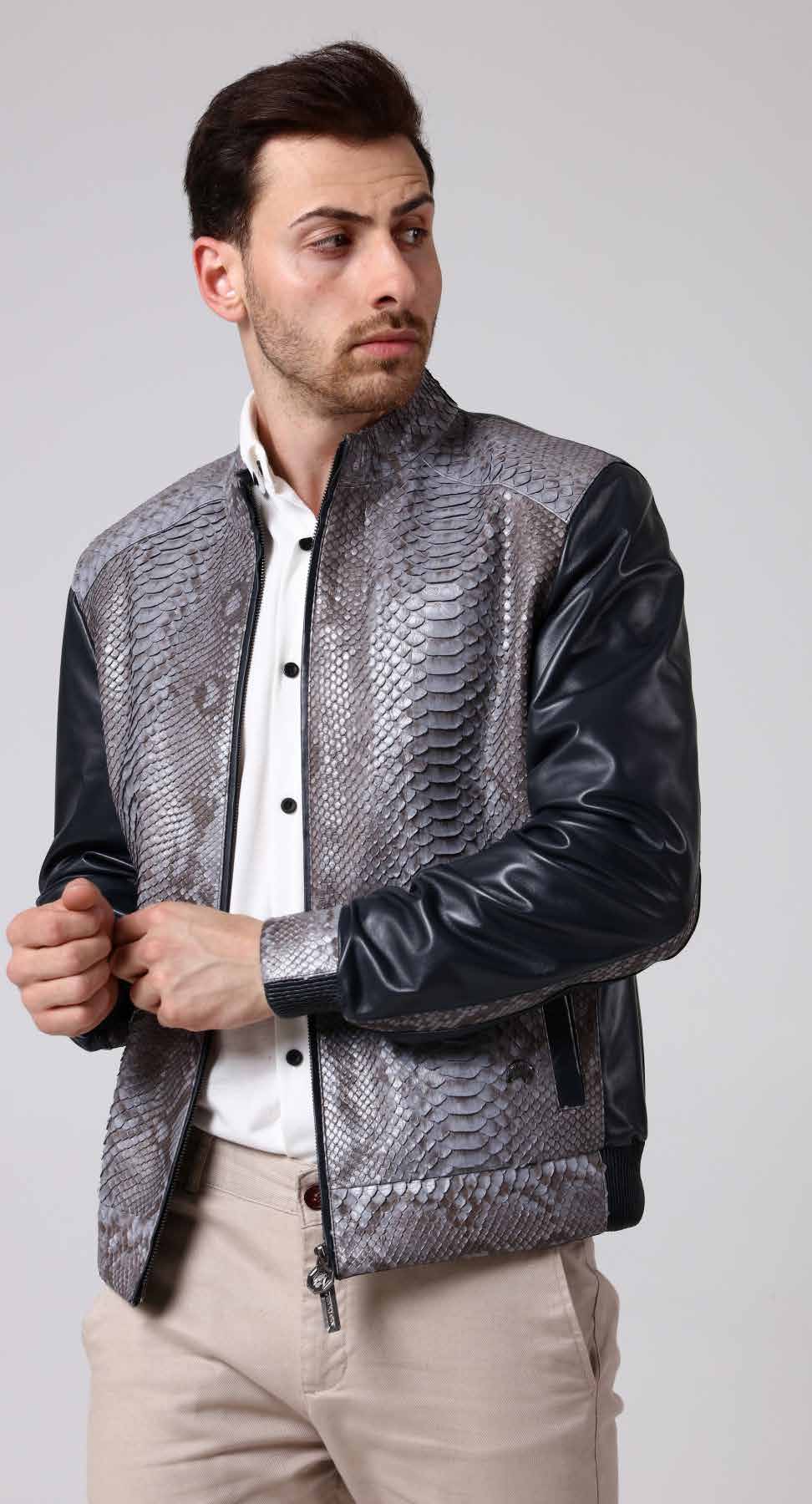 Man wearing a gray snakeskin pattern jacket with black leather sleeves on a light gray background