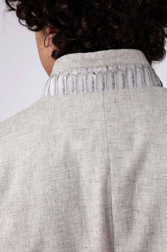 Close-up of a light gray jacket with a textured collar on a plain background