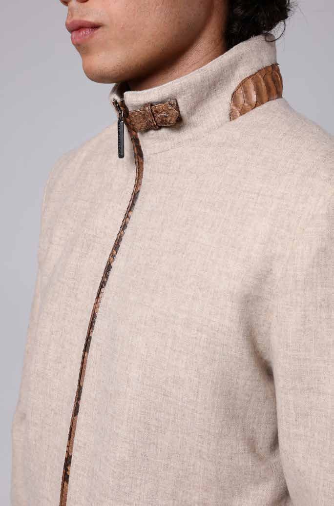 Close-up of a beige textured jacket with brown leather accents on a gray background