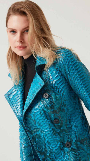 Woman wearing a blue phyton jacket on a white background