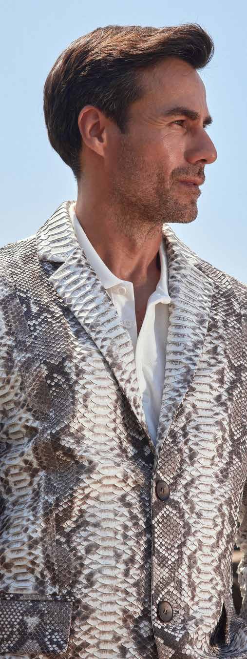 Man wearing a patterned jacket with a blurred background