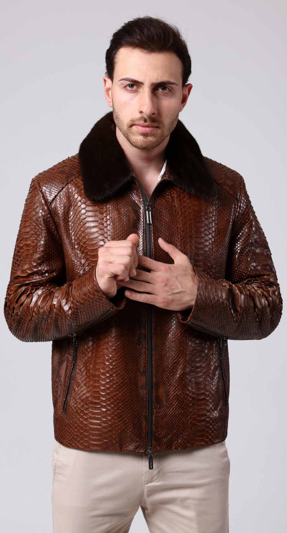 Man wearing a brown leather jacket with a textured pattern on a plain background