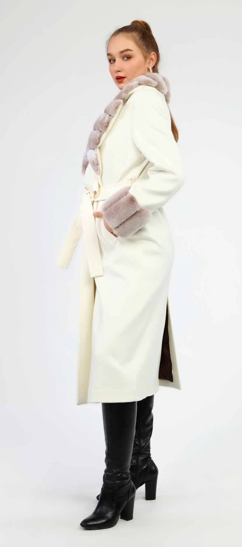 Woman wearing a long white coat with fur trim on a white background