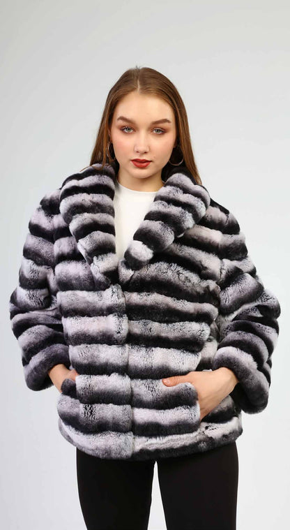 Woman wearing a gray fur coat against a white background