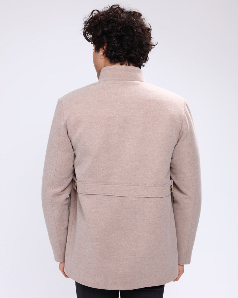 Man wearing a beige coat on a white background