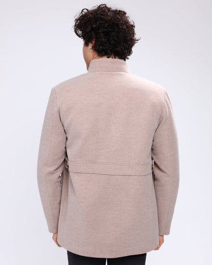 Man wearing a beige coat on a white background