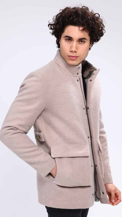 Man wearing a light brown coat with a fur-lined hood on a white background