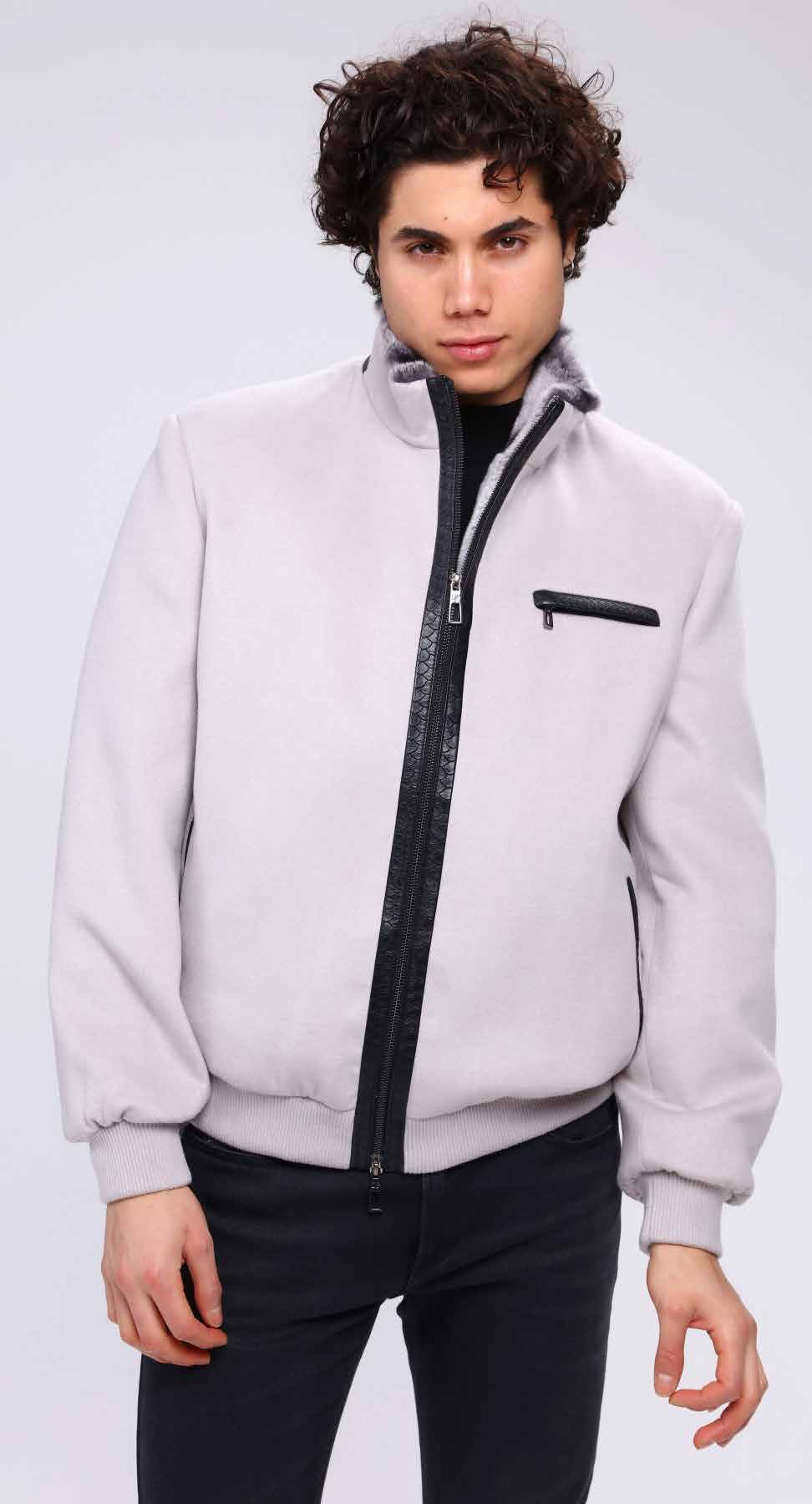 Man wearing a light gray jacket with a black zipper on a white background