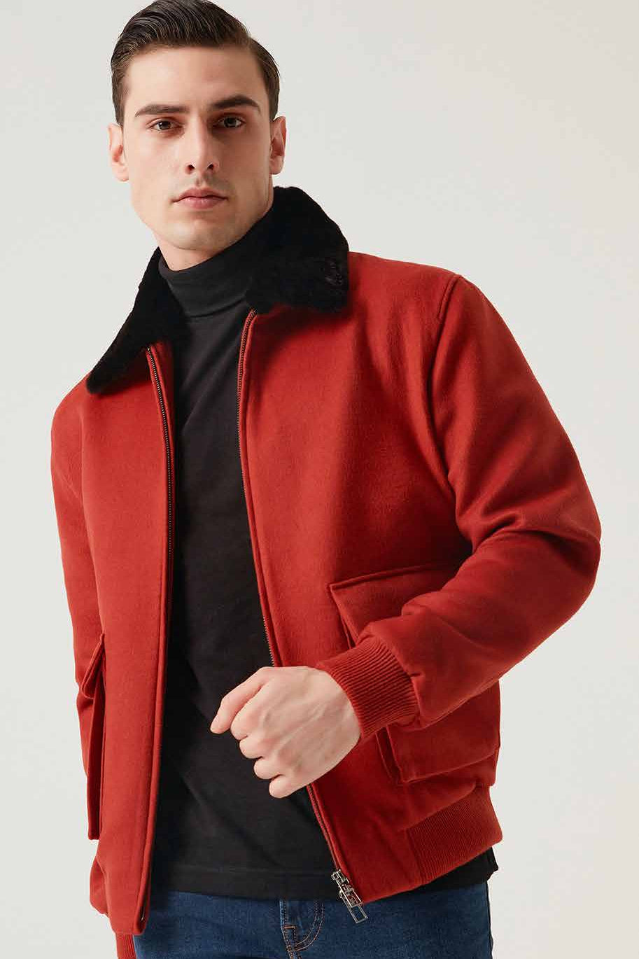 Man wearing a red jacket with a black collar on a white background