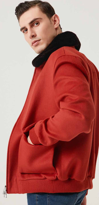Man wearing a red jacket with a fur-lined hood on a white background