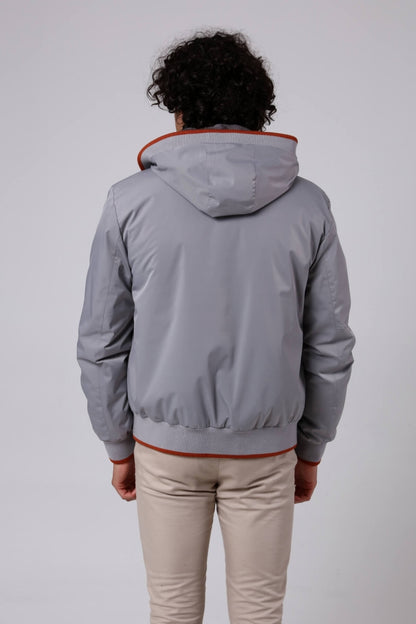 Man wearing a gray jacket with red trim on a white background