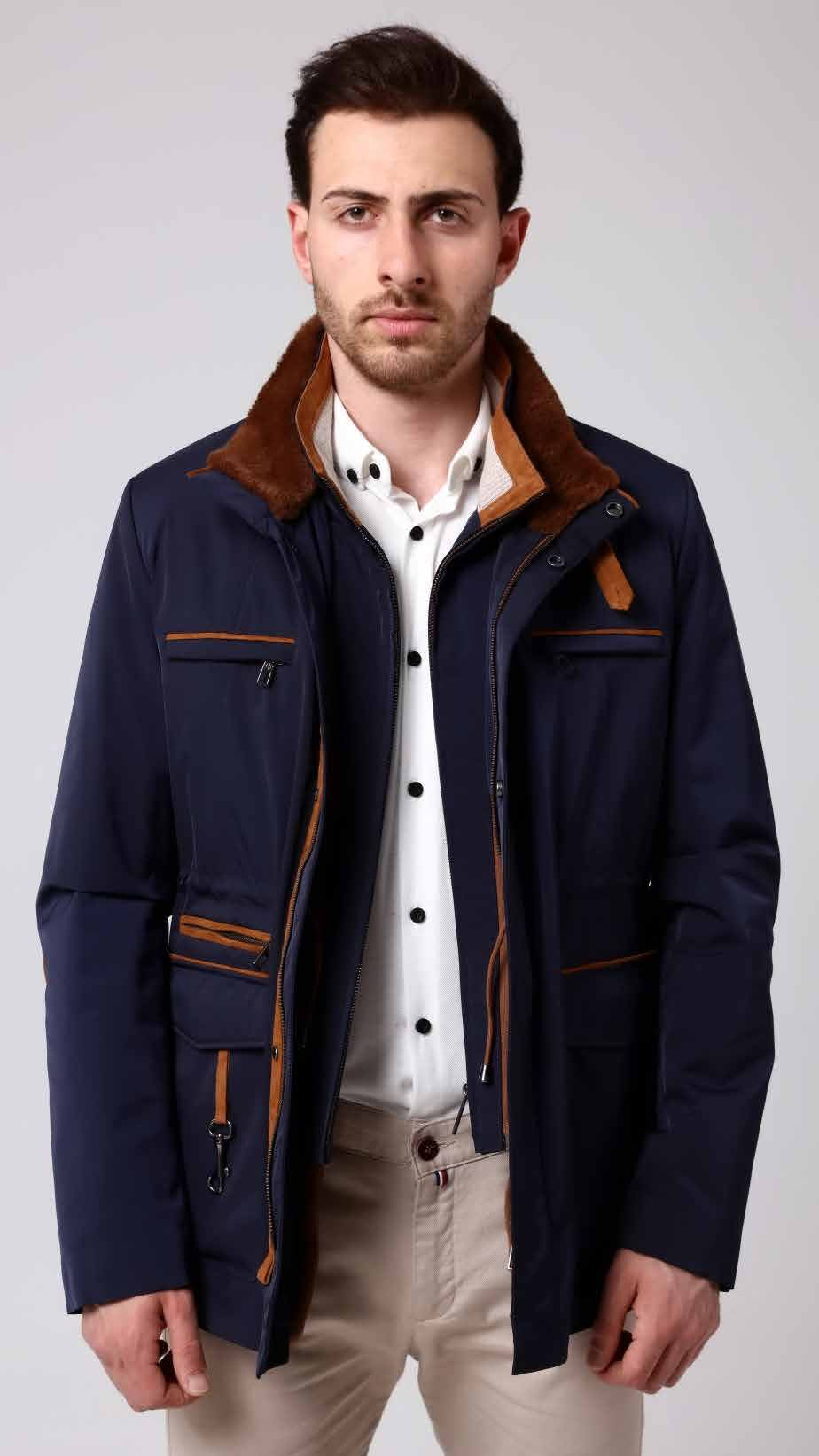 Man wearing a navy blue coat with brown accents on a white background