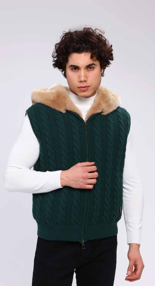 Man wearing a green knitted vest with fur collar on a white background