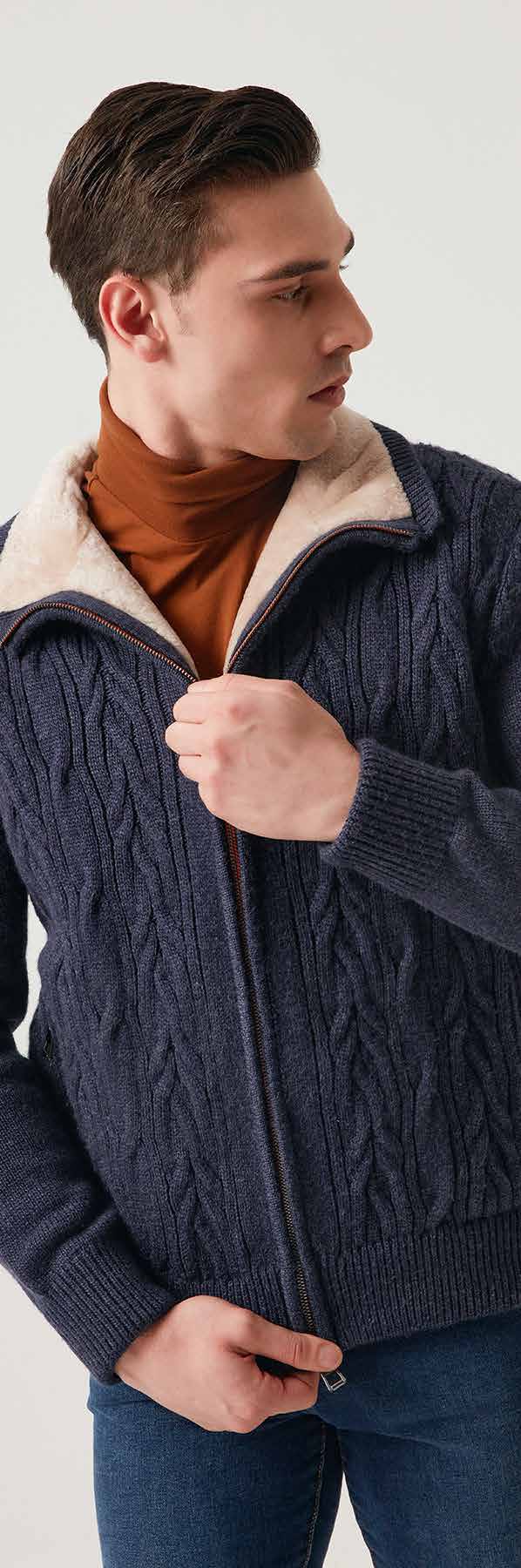 Man wearing a dark blue cable knit jacket with a beige interior lining.