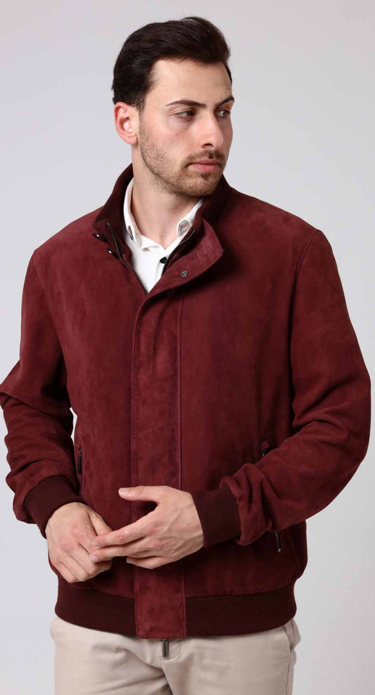 Man wearing a burgundy jacket on a plain background