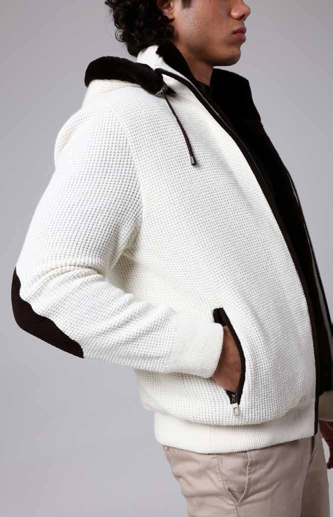 Man wearing a white fleece jacket with black accents on a gray background